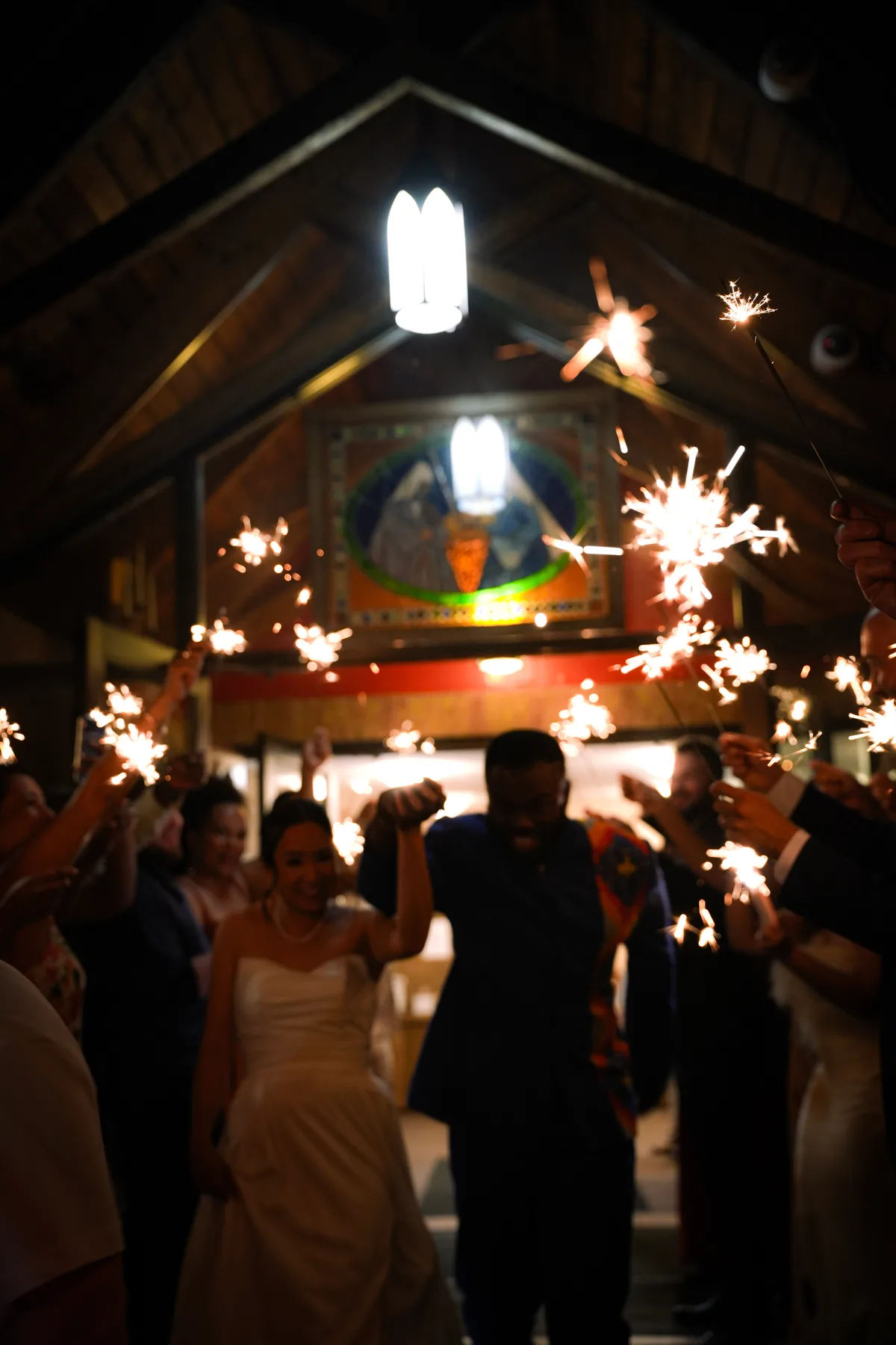 Guests holding sparklers as a celebration moves into the evening